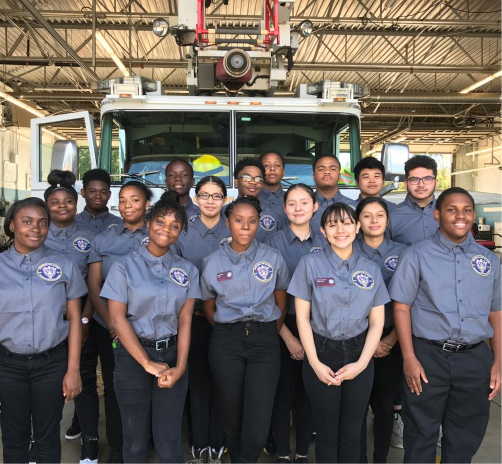Group of students in uniform in front of fire truck